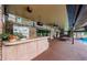 Spacious outdoor bar featuring brick accents, ceiling fans, and lounge chairs near the pool at 309 Hidden Lake Dr, Brandon, FL 33511
