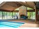 The indoor pool area offers a built-in grill and lounge area, perfect for year-round enjoyment and entertainment at 309 Hidden Lake Dr, Brandon, FL 33511