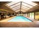 Spectacular indoor pool under a vaulted transparent ceiling, ideal for year-round swimming and relaxation in a private oasis at 309 Hidden Lake Dr, Brandon, FL 33511