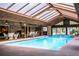 Stunning indoor pool area with a transparent ceiling, a hot tub and elegant furnishings for relaxation and entertainment at 309 Hidden Lake Dr, Brandon, FL 33511