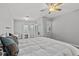 Spacious bedroom with plush bedding and a bright ceiling fan at 3138 Deergrass Ct, Holiday, FL 34691