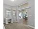 Bedroom featuring a sliding glass door, neutral carpet and a built in desk at 3138 Deergrass Ct, Holiday, FL 34691