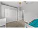 Cozy bedroom with a closet, ceiling fan, and a twin bed, complemented by a neutral color scheme at 3138 Deergrass Ct, Holiday, FL 34691