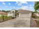 A bright home with a large driveway and well-maintained landscaping at 3138 Deergrass Ct, Holiday, FL 34691