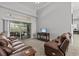 Cozy living room with sliding glass doors, comfortable seating, and neutral decor at 3138 Deergrass Ct, Holiday, FL 34691