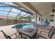 Relaxing screened-in pool area with a jacuzzi, lounge chairs, and outdoor dining at 3138 Deergrass Ct, Holiday, FL 34691