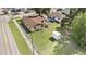 Aerial view of a home with a fenced yard, detached garage, and proximity to neighborhood amenities at 3201 E Mcberry St, Tampa, FL 33610