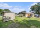 Enjoy a large fenced backyard with a shed and ample space for outdoor activities and potential expansion at 3201 E Mcberry St, Tampa, FL 33610