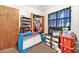 Bedroom used as storage, featuring window with dark curtains, a filled closet and toy storage at 3201 E Mcberry St, Tampa, FL 33610