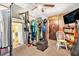 Bedroom featuring a ceiling fan, TV, closet with clothing rack, and storage for an organized space at 3201 E Mcberry St, Tampa, FL 33610