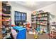 Bedroom used as storage, featuring window with dark curtains, shelves, and toys at 3201 E Mcberry St, Tampa, FL 33610