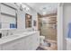 Bright bathroom features double sinks, large mirrors, and a glass walk-in shower at 3271 Mcmath Dr, Palm Harbor, FL 34684