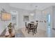 Bright dining room with a charming chandelier, adjacent to the entry, and offers a welcoming ambiance at 3271 Mcmath Dr, Palm Harbor, FL 34684