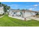 Charming home exterior featuring a cozy patio area, lush green lawn, and attached garage at 3271 Mcmath Dr, Palm Harbor, FL 34684