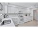 Updated kitchen featuring sleek countertops, white cabinetry, and modern appliances for a contemporary feel at 3271 Mcmath Dr, Palm Harbor, FL 34684