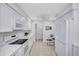 Bright kitchen with modern appliances, white cabinets, and breakfast table, creating a functional and inviting space at 3271 Mcmath Dr, Palm Harbor, FL 34684