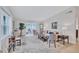 Bright and airy living room with light wood floors, large windows, and comfortable seating at 3271 Mcmath Dr, Palm Harbor, FL 34684