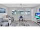 Bright living room featuring modern décor, large windows, and comfortable seating arrangements at 3271 Mcmath Dr, Palm Harbor, FL 34684
