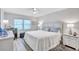 Bright main bedroom features a ceiling fan, neutral paint, and wood-look floors at 3271 Mcmath Dr, Palm Harbor, FL 34684