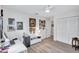 Spare bedroom with neutral walls, wood-look floors, and abundant artwork at 3271 Mcmath Dr, Palm Harbor, FL 34684