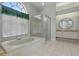 Bathroom with large tub, walk-in shower, and vanity with stone countertops at 3457 Foxhall Dr, Holiday, FL 34691