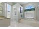Bathroom featuring a soaking tub, shower, granite countertop vanity and arched window at 3457 Foxhall Dr, Holiday, FL 34691