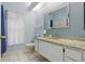 Bathroom featuring a granite countertop, large mirror, and a toilet next to the vanity at 3457 Foxhall Dr, Holiday, FL 34691