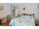 Cozy bedroom with a wooden bed frame, blue patterned quilt, and light purple walls at 3457 Foxhall Dr, Holiday, FL 34691