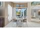 Cozy dining area features a round table with seating for four and large windows at 3457 Foxhall Dr, Holiday, FL 34691