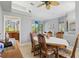 The dining room with a window, chandelier and view of the living room and kitchen at 3457 Foxhall Dr, Holiday, FL 34691