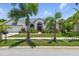 Charming single-Gathering home with a well-manicured lawn, mature landscaping, and a bright red front door at 3457 Foxhall Dr, Holiday, FL 34691