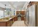 Well-lit kitchen equipped with stainless steel appliances and granite countertops at 3457 Foxhall Dr, Holiday, FL 34691