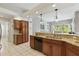 Open kitchen with granite counters, stainless steel sink, and view into the living area at 3457 Foxhall Dr, Holiday, FL 34691