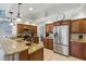 Eat-in kitchen featuring stainless steel appliances, granite countertops, and wooden cabinetry at 3457 Foxhall Dr, Holiday, FL 34691