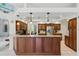 Well-equipped kitchen with wooden cabinetry, granite countertops and stainless steel appliances at 3457 Foxhall Dr, Holiday, FL 34691