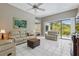 Bright living room featuring tile floors, comfortable furniture, and access to outdoor view at 3457 Foxhall Dr, Holiday, FL 34691