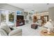 Open-concept living room with tile floors, seamless flow to kitchen, and access to the pool at 3457 Foxhall Dr, Holiday, FL 34691