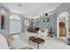 Open-concept living room adjoining a dining area and kitchen, flooded with natural light from large windows at 3457 Foxhall Dr, Holiday, FL 34691