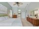 Bedroom with a bed, dual dressers, light green walls, and natural light at 3457 Foxhall Dr, Holiday, FL 34691