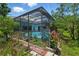 Backyard view showcasing a screened-in pool and landscaped surroundings, perfect for relaxation at 3457 Foxhall Dr, Holiday, FL 34691