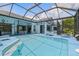 Inviting screened-in pool area offers a relaxing oasis for outdoor enjoyment and entertaining in style at 3457 Foxhall Dr, Holiday, FL 34691