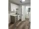 Updated laundry room with stylish cabinets, new sink and faucet, offering convenience and modern flair at 3844 Cedarwood Dr, Holiday, FL 34691