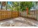 Outdoor patio space with a privacy fence and lush tropical landscaping at 409 S Audubon Ave # 3, Tampa, FL 33609