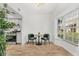 Bright dining area with a modern table, green chairs, and a large window next to the modern kitchen at 409 S Audubon Ave # 3, Tampa, FL 33609