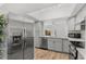Well-lit kitchen boasts stainless steel appliances, quartz countertops, and sleek gray cabinets with modern fixtures at 409 S Audubon Ave # 3, Tampa, FL 33609