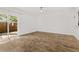 Bright living room with wood-look tile flooring and sliding glass doors to the backyard at 409 S Audubon Ave # 3, Tampa, FL 33609