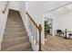 Bright staircase with wood and iron railing leading to an open-concept dining area and kitchen at 409 S Audubon Ave # 3, Tampa, FL 33609