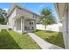 The backyard features a covered patio, grass, a walkway, and a tree at 4206 W North B St # 1, Tampa, FL 33609
