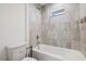 Bathtub in the bathroom featuring a tiled shower with window at 4206 W North B St # 1, Tampa, FL 33609