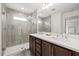 Bathroom featuring a double vanity, large mirror, tiled shower, and modern finishes and lots of light at 4206 W North B St # 1, Tampa, FL 33609